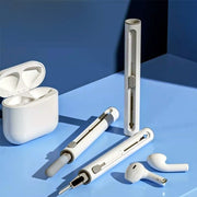 White electronic devices including a case and earbuds on a blue surface