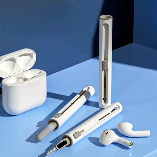 White electronic devices including a case and earbuds on a blue surface